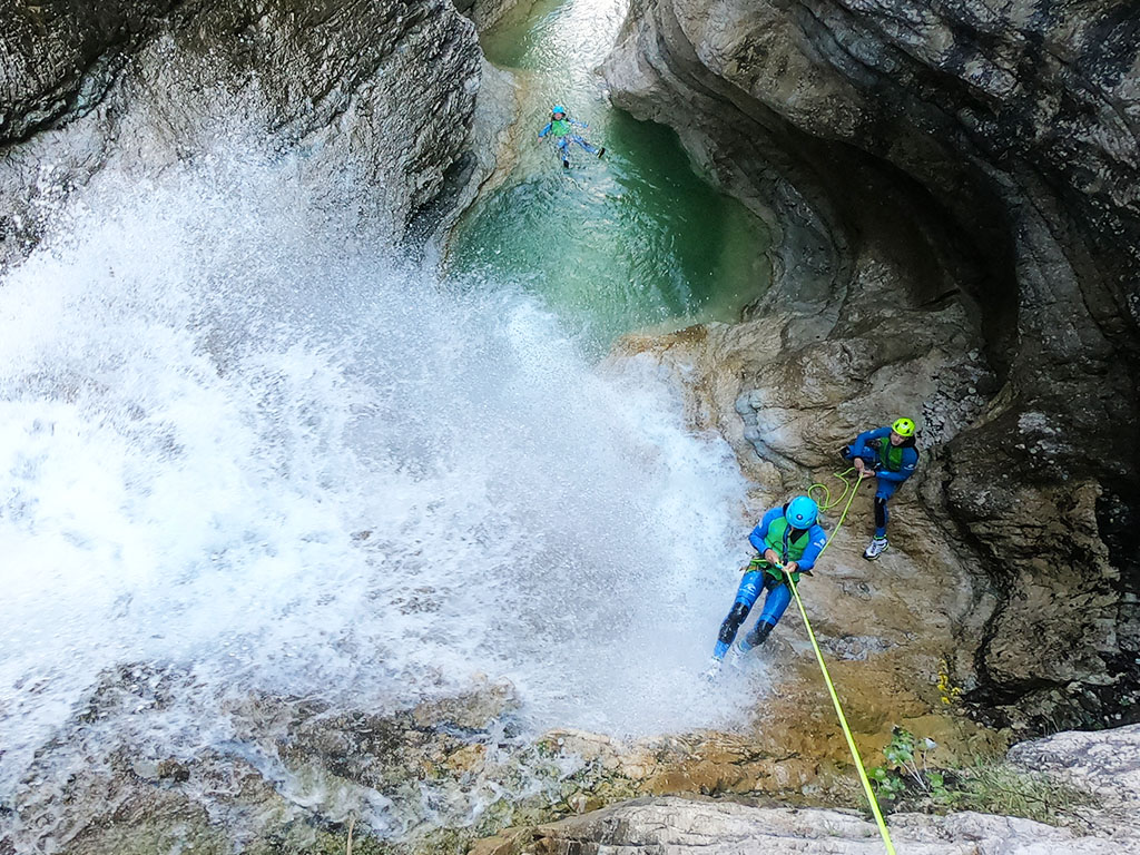 Rappeling a waterfall in lower Predelica canyon.